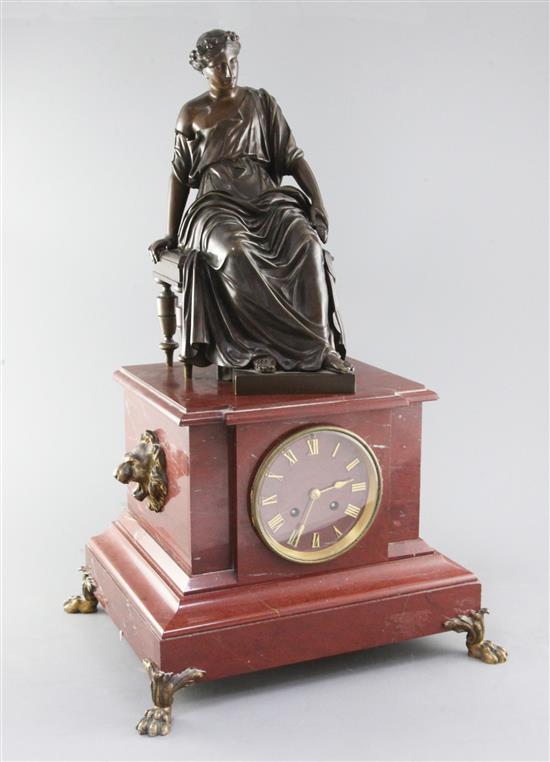 A 19th century French bronze and rouge marble mantel clock, 21.5in.